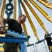 Ride jock Robert Clary works with Josh Hare to assemble the Yoyo attraction for the Jaycees' Summer Carnival at Pioneer High School on Tuesday, June 25. Daniel Brenner I AnnArbor.com